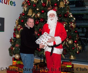 Team owner, Neil Morris, helps Santa with the presents