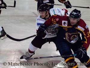 Andy McKinney battles it out at a face-off with Guildford Flame, Curtis Huppe