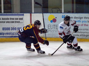 James Archers turns for puck while being chased by a Guildford player