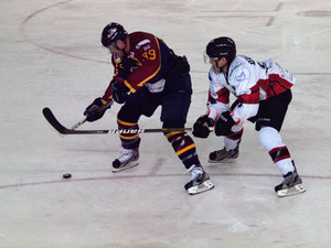 Tom Duggan fights for the puck