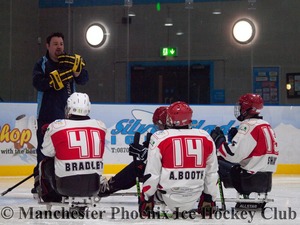 Coach Pete Hagan and players of the Sledge hockey team