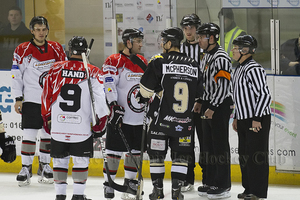 The penalty call on Frantisek Bakrlik is debated by both teams and the officials
