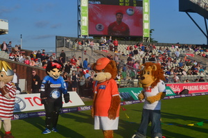 The Menace is standing back watching the other mascots