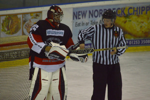 Steve Fone returns the puck to the official