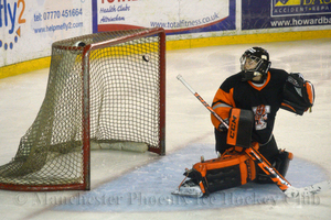 The puck passes by Tom Murdy for Phoenix's second goal