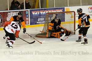 James Neil fires the puck over the head of Thomas Murdy