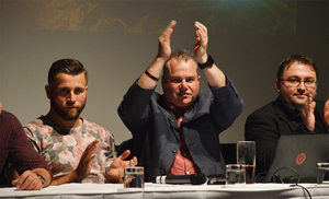 Neil Morris clapping the audience at the top table