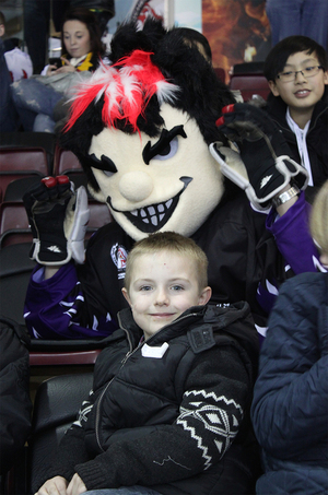 The Menace poses with a young fan