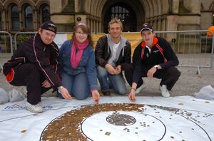 Rhys McWilliams, Monica Rapacz, Scott Wright, and Nick Whyatt with the coin painting.